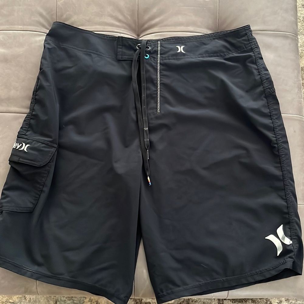 Mens Hurley size 36 black board shorts with silver / white logos. Front pocket.